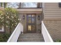 Elegant front entrance with brick steps and a beautifully designed glass-paneled door at 2630 Orchard Knob Se, Atlanta, GA 30339