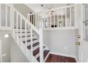 Bright entryway with hardwood floors, white railings, and stairs leading to an open living space at 3136 Taffy Ln, Snellville, GA 30039