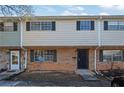 Townhome exterior with stone accents, window shutters, and a small front yard area at 4701 Flat Shoals Rd # 49C, Union City, GA 30291