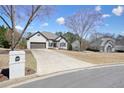 Beautiful home featuring a brick exterior, a two-car garage, and a large, sloping front yard at 1090 Compton Way, Suwanee, GA 30024