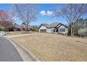 Charming home featuring a brick exterior, a two-car garage, and a spacious front yard at 1090 Compton Way, Suwanee, GA 30024