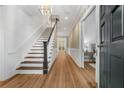 Bright foyer featuring hardwood floors, staircase, and decorative wall trim at 3582 Grove Gate Ln, Atlanta, GA 30339
