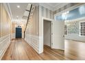 Elegant foyer with hardwood floors, stylish wallpaper, and detailed trim work at 3582 Grove Gate Ln, Atlanta, GA 30339