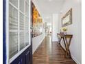 Inviting entryway with wood floors, decorative console table, and colorful artwork at 1484 Ben Park Way, Grayson, GA 30017