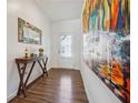 Hallway with wood-look floors, console table with decorations and decorative mirror at 1484 Ben Park Way, Grayson, GA 30017