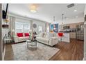 Open-concept living area with white sofas, modern decor, and seamless flow to the kitchen at 1484 Ben Park Way, Grayson, GA 30017