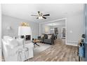 Bright living room boasts hardwood floors, a cozy fireplace, and neutral color scheme at 2735 Varlet Ct, Snellville, GA 30039