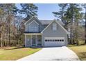 Charming two-story home featuring an attached two-car garage, and well-manicured front lawn and front porch at 300 The Esplanade Se Way, Loganville, GA 30052