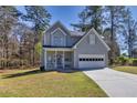 Charming two-story home featuring an attached two-car garage, well-manicured front lawn and covered porch at 300 The Esplanade Se Way, Loganville, GA 30052