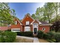 Traditional brick home boasts a well-maintained lawn, trimmed bushes, and welcoming entryway at 3117 Kings Arms Ne Ct, Atlanta, GA 30345