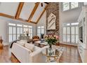 Bright living room boasting a stone fireplace, vaulted ceilings, and elegant window shutters at 6950 Kettering Ln, Suwanee, GA 30024