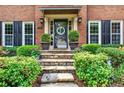 Stone steps leading up to front door with decorative wreath and lush landscaping at 2138 Jockey Hollow Nw Dr, Kennesaw, GA 30152