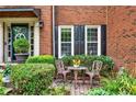 Cozy front porch with seating area and charming brick details at 2138 Jockey Hollow Nw Dr, Kennesaw, GA 30152