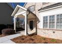 Inviting front porch with brick facade and craftsman-style details at 1300 Winfair Ne Ln, Brookhaven, GA 30329