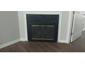 Cozy fireplace with glass doors and detailed trim, set against wood-look floors at 315 Dressage Ct, Riverdale, GA 30296