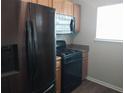 Modern kitchen features stainless steel refrigerator, gas range, and overhead microwave at 315 Dressage Ct, Riverdale, GA 30296