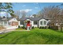 Lovely bungalow with bright red front door and well-kept lawn in a desirable neighborhood at 1683 Emerald Sw Ave, Atlanta, GA 30310