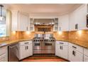 Well-equipped kitchen featuring stainless steel appliances, granite countertops, and white cabinets at 263 Ohm Ave, Avondale Estates, GA 30002