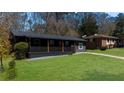 Charming ranch-style home with a welcoming front porch and a lush green lawn at 282 Oak Se Dr, Atlanta, GA 30354