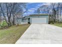 Inviting home with a large driveway leading to a two-car garage and a neatly kept front yard at 639 Oak Moss Dr, Lawrenceville, GA 30043