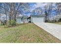 Attractive single-Gathering home with a driveway and a well-manicured lawn, framed by flowering trees at 639 Oak Moss Dr, Lawrenceville, GA 30043