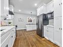 Modern kitchen with stainless steel appliances, white cabinets, quartz countertops, and hardwood floors at 276 Hermer Nw Cir, Atlanta, GA 30311
