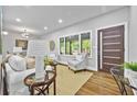 Bright living room featuring hardwood floors, large windows, and stylish decor for a cozy, inviting atmosphere at 276 Hermer Nw Cir, Atlanta, GA 30311