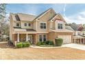 Attractive two-story home with stone accents, well-manicured lawn, and a cozy front porch at 3452 Village Park Sw Ln, Atlanta, GA 30331