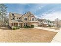 Beautiful two-story home with well-manicured landscaping and a long driveway in a suburban neighborhood at 3452 Village Park Sw Ln, Atlanta, GA 30331