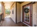 Inviting porch with hardwood floors and an elegant front door adorned with a welcoming wreath at 1346 Stillwood Chase Ne, Atlanta, GA 30306