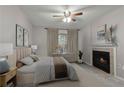 Cozy main bedroom featuring a ceiling fan, fireplace, and natural light at 3655 Habersham Ne Rd # 215, Atlanta, GA 30305