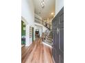 Bright foyer with hardwood floors, a staircase, and views into other living spaces at 4118 Kentmere Main Nw, Kennesaw, GA 30144