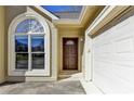 Close-up of front door, arched window, and attached two-car garage at 1450 Pinyon Pl, Lawrenceville, GA 30043