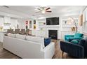 Open concept living space with fireplace, built-ins, and seamless flow into kitchen at 2855 Mcmurtry St, Cumming, GA 30041