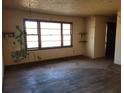 Spacious living room with hardwood floors, a large window, and unique architectural details at 121 Mcgiboney Rd, Covington, GA 30016