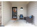 Covered front porch with seating, stylish door, and a welcoming ambiance at 2450 Mildon Hall Ln, Lawrenceville, GA 30043