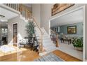Inviting foyer with wood flooring, staircase, and views into the living room at 3202 Eagle Watch Dr, Woodstock, GA 30189