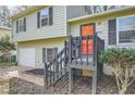 Split-level home featuring an orange front door with black shutters and gray siding at 840 Wells Se Cir, Smyrna, GA 30080