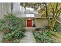Charming home with a red door, mature landscaping, and a welcoming entrance at 311 Maranatha Trl, Lawrenceville, GA 30045