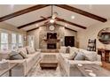 Comfortable living area with stone fireplace, wood beams and access to outdoor views at 311 Maranatha Trl, Lawrenceville, GA 30045
