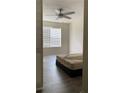 Bright bedroom features a ceiling fan, wide window with blinds, and wood-look flooring at 72 Belmonte Sw Cir, Atlanta, GA 30311