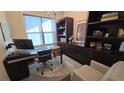 A stylish home office featuring built-in shelves, a modern desk, an ergonomic chair and lots of natural light at 112 Austin Dr, Sandy Springs, GA 30328