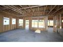 Interior view of a house under construction featuring concrete floors and exposed wood framing at 2044 Ripple Park Bnd, Canton, GA 30114