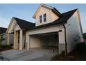 Side view of a lovely house featuring a two-car garage and white siding at 2044 Ripple Park Bnd, Canton, GA 30114