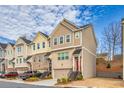 Charming row of townhomes with a mix of brick and siding exteriors and small front gardens at 2527 Hedgeway Cir, Kennesaw, GA 30144