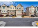 Street view showing a row of modern townhomes with attached garages and tidy front yards at 2527 Hedgeway Cir, Kennesaw, GA 30144