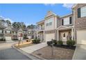 Street view of inviting townhomes with attached garages, quaint balconies, and well-maintained landscaping at 7206 Begonia Way # 4, Austell, GA 30168