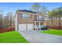 Beautiful brick home boasts a two-car garage, welcoming porch, and well-maintained landscaping at 13699 Inman Rd, Hampton, GA 30228