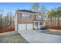 Beautiful brick home boasts a two-car garage, welcoming porch, and well-maintained landscaping at 13699 Inman Rd, Hampton, GA 30228