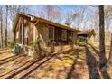 Wood and stone exterior with a well-manicured yard and a glimpse of a detached garage at 166 Muse Rd, Fayetteville, GA 30214